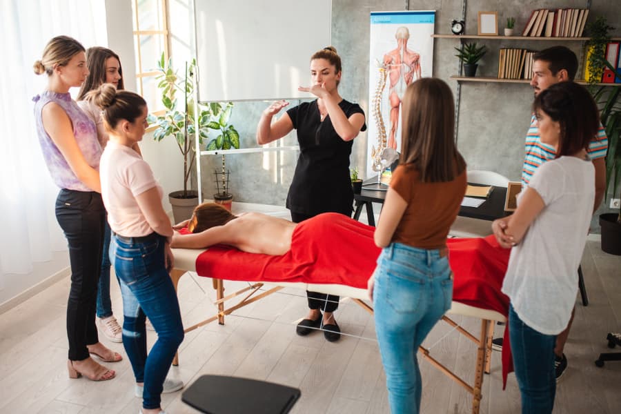 Massage therapist teaching students