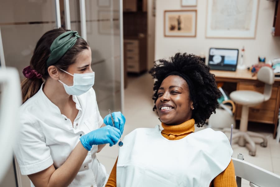 Dental assistant working with patient