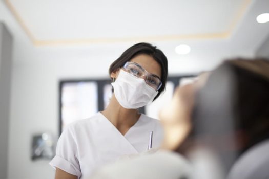 A Dental Assistant Working With A Patient