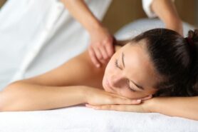 Person receiving back massage in spa