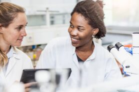 Pharmacy technician students discussing lesson in lab