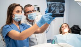 Portrait of a dentist holding x-ray image