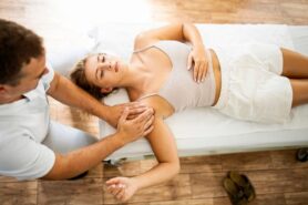 Professional massage therapist doing therapeutic massage with pressure points