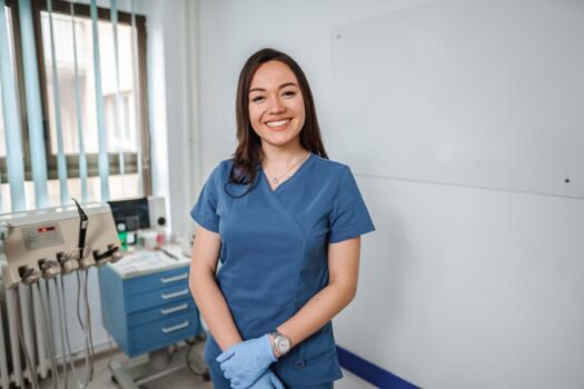 Smiling dental assistant in clinical room