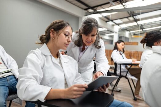 Teacher helping medical student in class